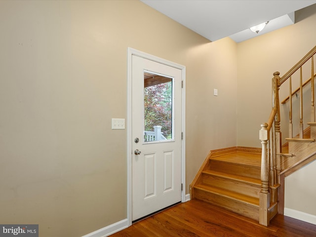doorway to outside with stairs, baseboards, and wood finished floors