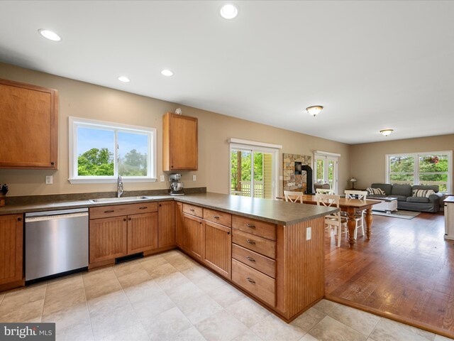 kitchen featuring dishwasher, a sink, plenty of natural light, recessed lighting, and a peninsula