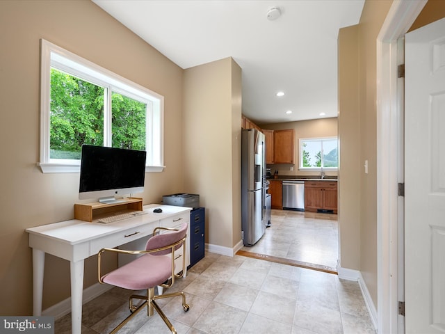 office featuring a sink, recessed lighting, baseboards, and light tile patterned floors