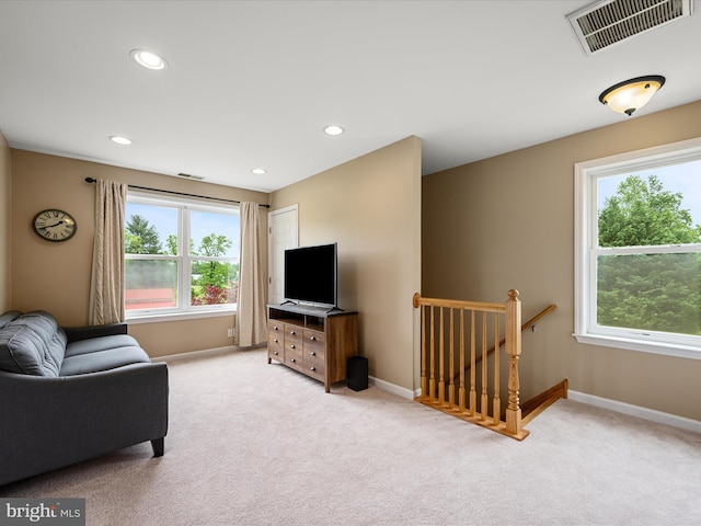 carpeted living room featuring baseboards and recessed lighting