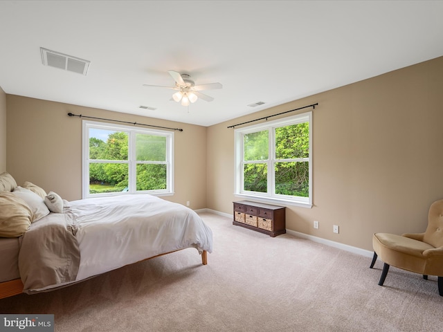 bedroom featuring baseboards, light carpet, and a ceiling fan