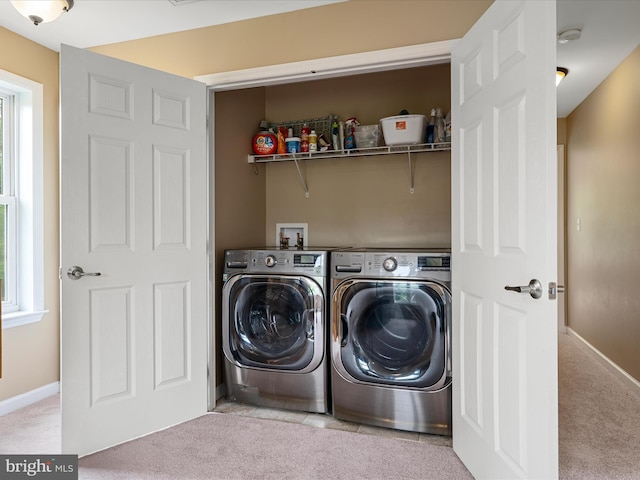laundry room with separate washer and dryer, carpet flooring, and baseboards
