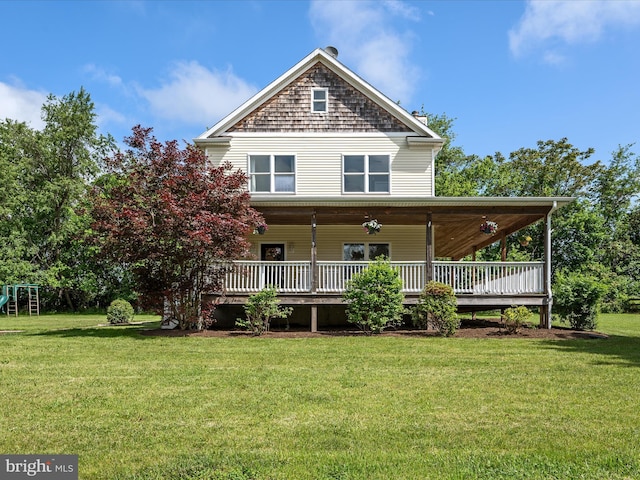 rear view of property with a yard and a deck