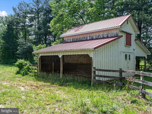 view of pole building with fence