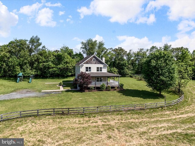 view of front of property featuring a chimney and a porch