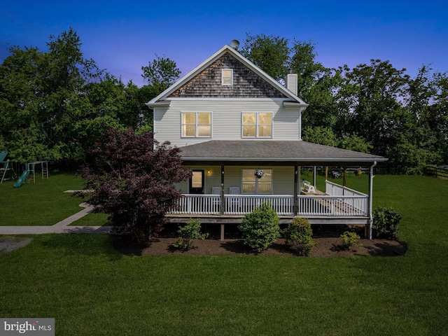 country-style home featuring a chimney, a front lawn, a porch, and a playground