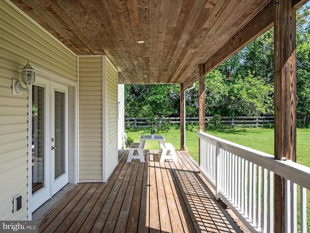 wooden deck with french doors and view of scattered trees