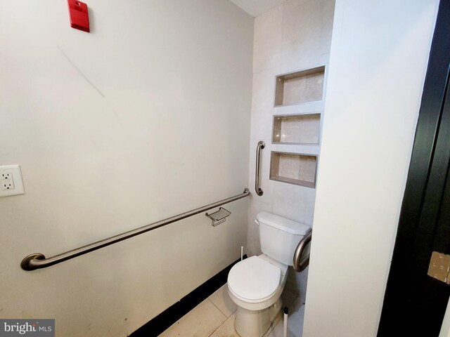 bathroom with toilet and tile patterned floors