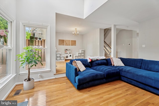 2000 Eton Ct Unit 2000, West Chester, PA 19382 - living room with stairway, wood finished floors, a chandelier, and baseboards