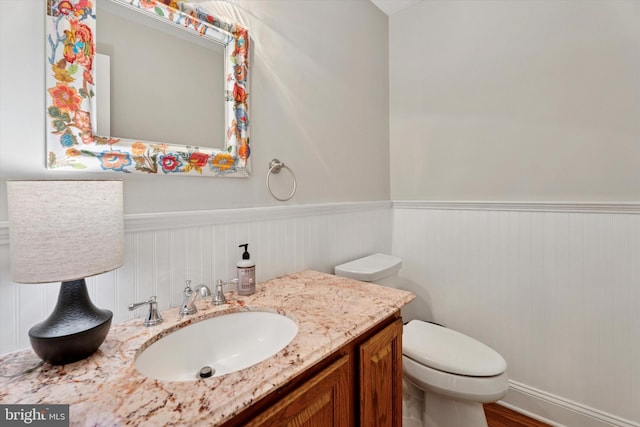 2000 Eton Ct Unit 2000, West Chester, PA 19382 - bathroom featuring a wainscoted wall, toilet, vanity, and wood finished floors