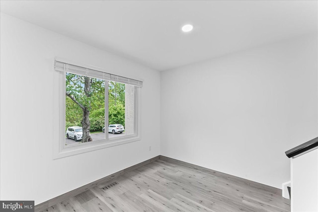 spare room with wood finished floors, recessed lighting, and baseboards
