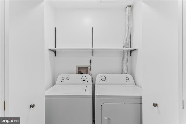 laundry area featuring washing machine and clothes dryer