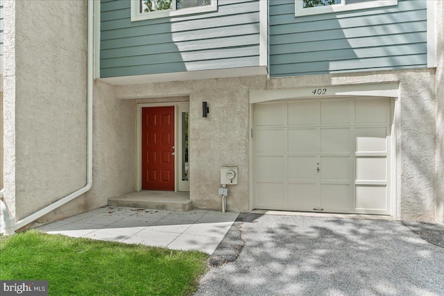 doorway to property featuring stucco siding