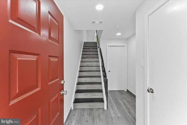 entrance foyer with stairway, light wood-type flooring, baseboards, and recessed lighting