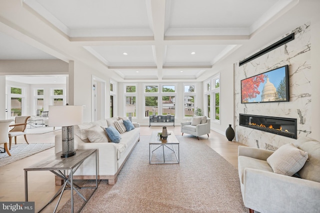 living room with coffered ceiling, beam ceiling, a high end fireplace, recessed lighting, and wood finished floors