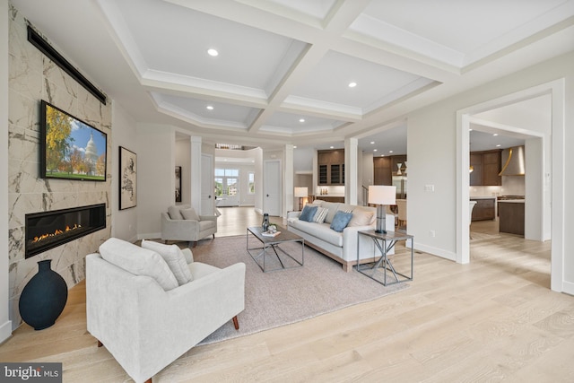 living room with a high end fireplace, coffered ceiling, light wood-style flooring, beamed ceiling, and recessed lighting