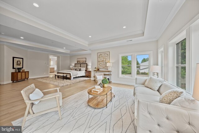 living room with a raised ceiling, wood finished floors, baseboards, ornamental molding, and recessed lighting