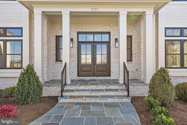 view of exterior entry with french doors and covered porch