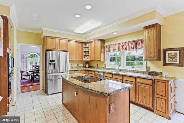 7103 Brookshire Ln, Clarksville, MD 21029 - kitchen with appliances with stainless steel finishes, a sink, ornamental molding, a center island, and light stone counters