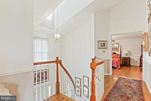 7103 Brookshire Ln, Clarksville, MD 21029 - hall with an upstairs landing, wood-type flooring, and a chandelier
