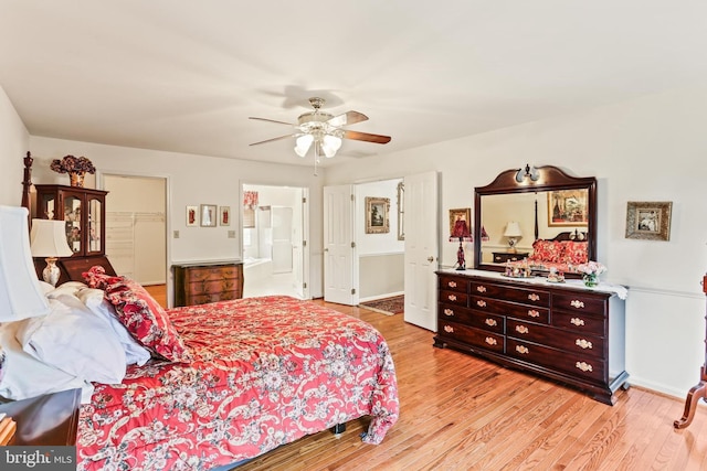 7103 Brookshire Ln, Clarksville, MD 21029 - bedroom featuring a walk in closet, light wood-style flooring, ensuite bath, a ceiling fan, and a closet