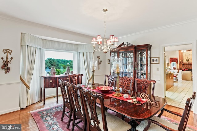 7103 Brookshire Ln, Clarksville, MD 21029 - dining room with a chandelier, ornamental molding, wood finished floors, and baseboards