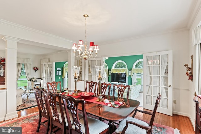 7103 Brookshire Ln, Clarksville, MD 21029 - dining area featuring healthy amount of natural light, wood finished floors, crown molding, and a chandelier