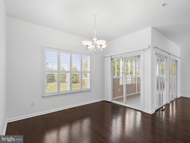 18880 Forgotten Harbor Ct Unit 402F, Rehoboth Beach, DE 19971 - spare room with a chandelier, plenty of natural light, wood finished floors, and baseboards