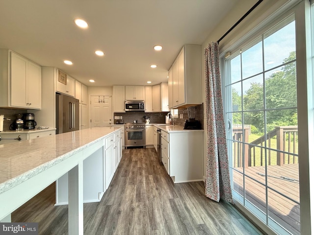 25977 Kildee Run, Mardela Springs, MD 21837 - kitchen with high end appliances, a sink, backsplash, dark wood-style floors, and white cabinets