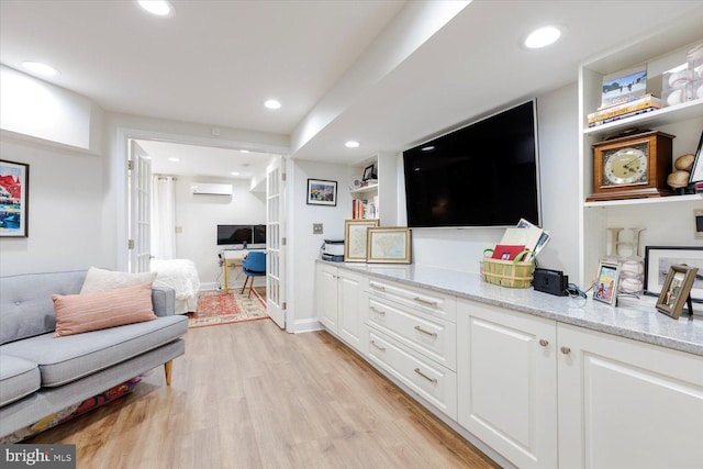 744 7th St SE, Washington, DC 20003 - living room featuring an AC wall unit, light wood-type flooring, and recessed lighting