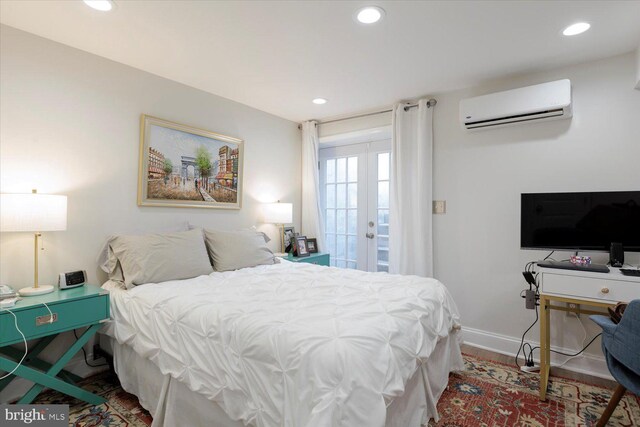 744 7th St SE, Washington, DC 20003 - bedroom featuring a wall mounted air conditioner, french doors, baseboards, recessed lighting, and wood finished floors
