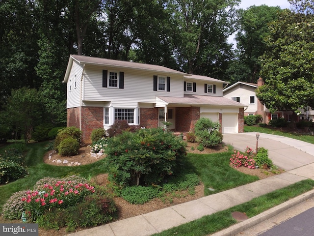 7750 Carrleigh Pkwy, Springfield, VA 22152 - view of front of home with brick siding, driveway, a front lawn, and a garage