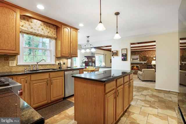 7750 Carrleigh Pkwy, Springfield, VA 22152 - kitchen with stainless steel dishwasher, a sink, a fireplace, decorative backsplash, and a center island