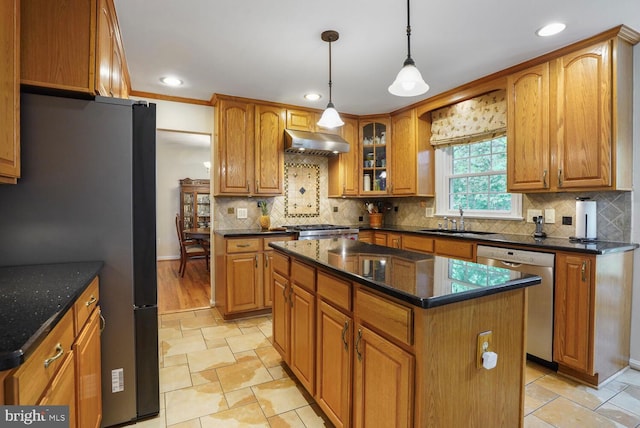 7750 Carrleigh Pkwy, Springfield, VA 22152 - kitchen featuring appliances with stainless steel finishes, under cabinet range hood, a sink, brown cabinets, and glass insert cabinets