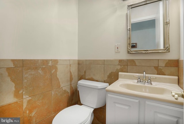 7750 Carrleigh Pkwy, Springfield, VA 22152 - bathroom with toilet, vanity, tile walls, and a wainscoted wall