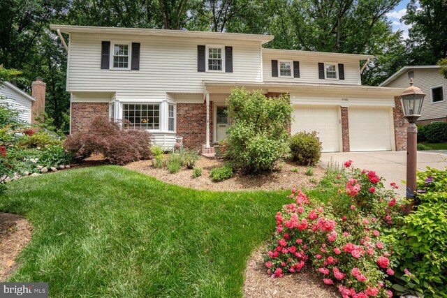 7750 Carrleigh Pkwy, Springfield, VA 22152 - view of front facade featuring concrete driveway, brick siding, and a front yard
