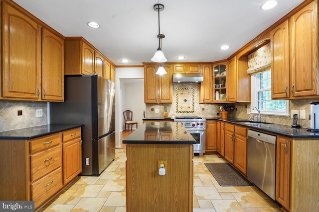 7750 Carrleigh Pkwy, Springfield, VA 22152 - kitchen featuring stainless steel appliances, under cabinet range hood, a sink, brown cabinets, and recessed lighting