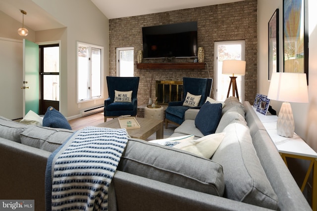 774 W Aaron Dr, State College, PA 16803 - living room with plenty of natural light, lofted ceiling, wood finished floors, a brick fireplace, and a baseboard radiator