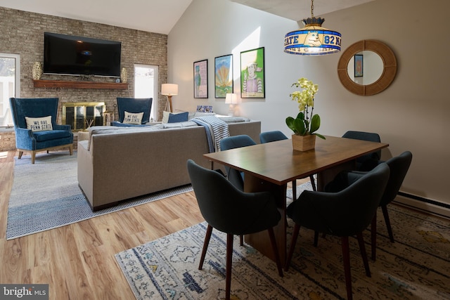 774 W Aaron Dr, State College, PA 16803 - dining area featuring vaulted ceiling, wood finished floors, and a fireplace