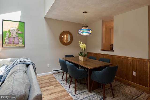 774 W Aaron Dr, State College, PA 16803 - dining area featuring baseboard heating, wood finished floors, wainscoting, wooden walls, and baseboards