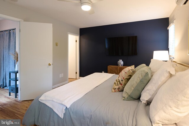 774 W Aaron Dr, State College, PA 16803 - bedroom with wood finished floors, ceiling fan, and a wall unit AC