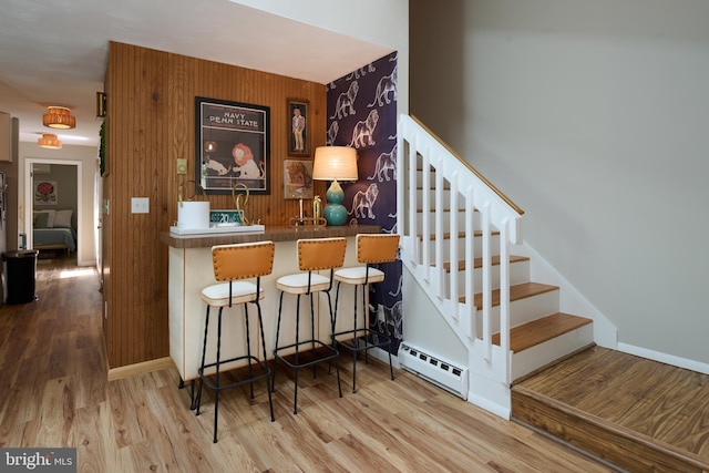 774 W Aaron Dr, State College, PA 16803 - bar area with baseboard heating, stairs, wood finished floors, and baseboards