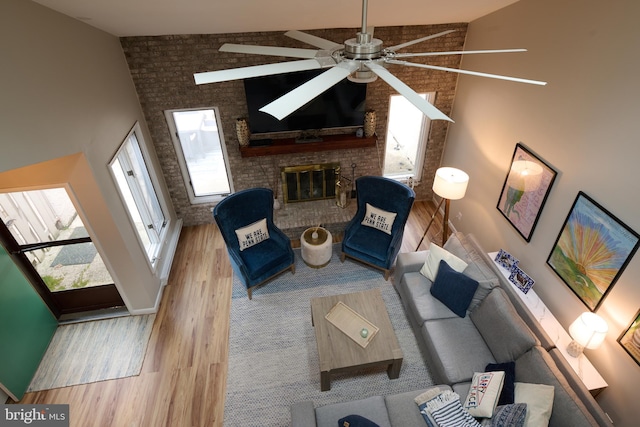 774 W Aaron Dr, State College, PA 16803 - living room with a ceiling fan, wood finished floors, a fireplace, baseboards, and a towering ceiling
