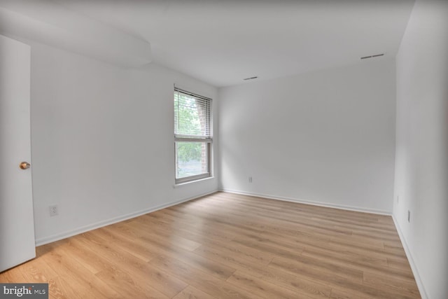 3320 Woodburn Village Dr Unit 32, Annandale, VA 22003 - spare room featuring light wood-type flooring and baseboards