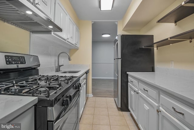 3320 Woodburn Village Dr Unit 32, Annandale, VA 22003 - kitchen featuring appliances with stainless steel finishes, under cabinet range hood, a sink, open shelves, and white cabinets