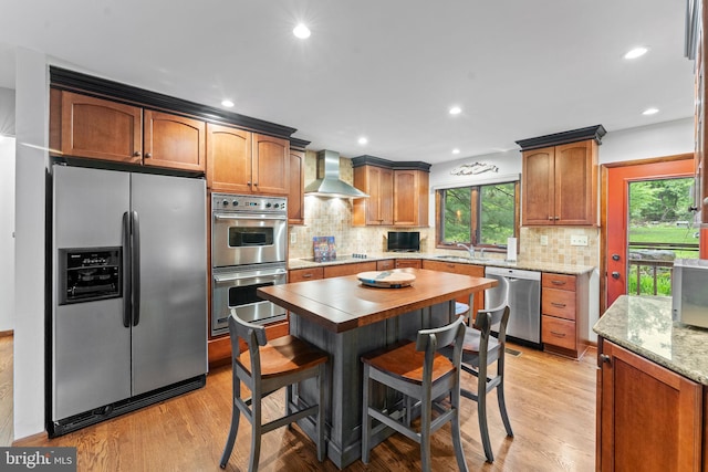 4 Fox Ridge Rd, Glenmoore, PA 19343 - kitchen featuring appliances with stainless steel finishes, light wood-type flooring, decorative backsplash, wall chimney range hood, and recessed lighting