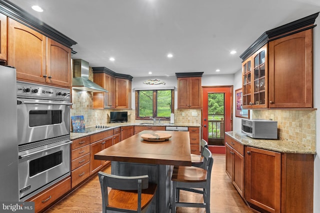 4 Fox Ridge Rd, Glenmoore, PA 19343 - kitchen with wall chimney exhaust hood, stainless steel appliances, light wood finished floors, glass insert cabinets, and tasteful backsplash