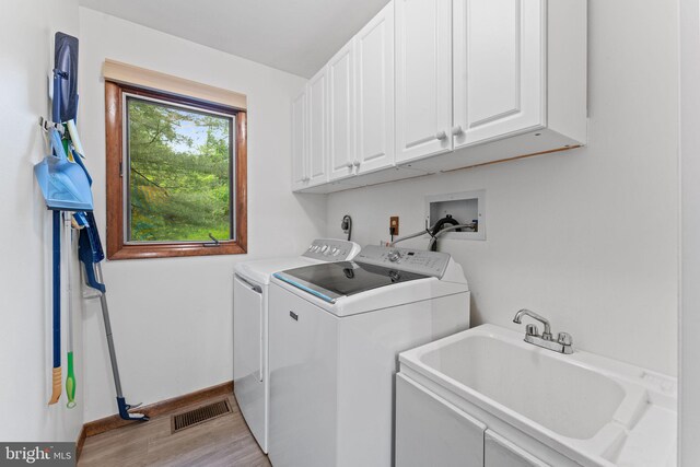 4 Fox Ridge Rd, Glenmoore, PA 19343 - clothes washing area with cabinet space, washing machine and dryer, light wood-type flooring, and baseboards