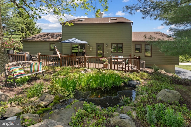 4 Fox Ridge Rd, Glenmoore, PA 19343 - back of property with a wooden deck, a small pond, and central AC unit
