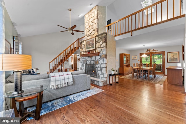 4 Fox Ridge Rd, Glenmoore, PA 19343 - living area with high vaulted ceiling, wood finished floors, ceiling fan, a stone fireplace, and stairs